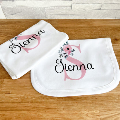 Personalised pink floral initial baby sleepsuit, printed with the child's custom name.