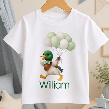 A white t-shirt with a cartoon duck holding green balloons and the name "William" printed on it.