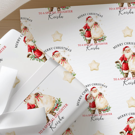 Personalised vintage Santa Christmas wrapping paper wrapped around a gift with cream ribbon, featuring a repeating Father Christmas design.