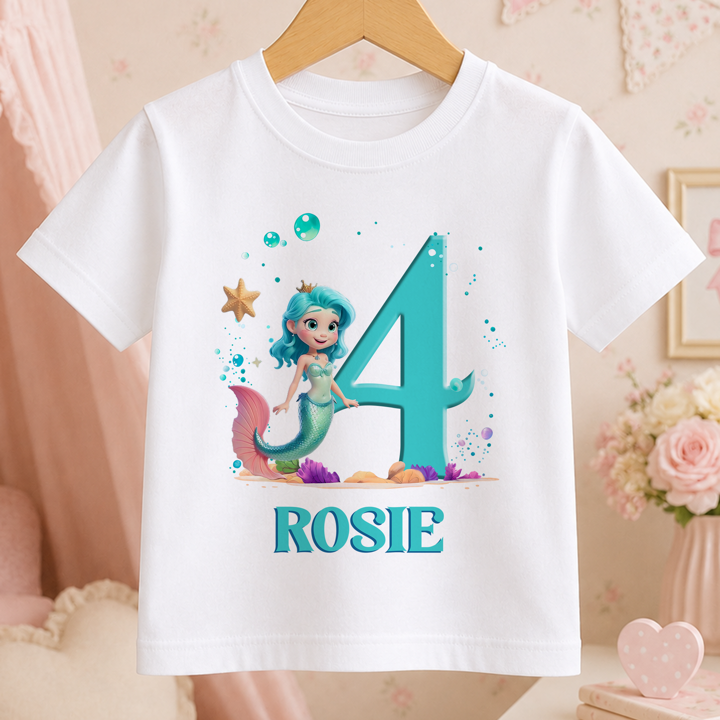 A white t-shirt with a mermaid character and the number 4 printed on it, along with the name "ROSIE".
