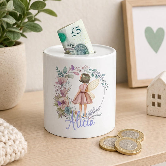 Ceramic money box printed with a personalised fairy design and sparkling wings