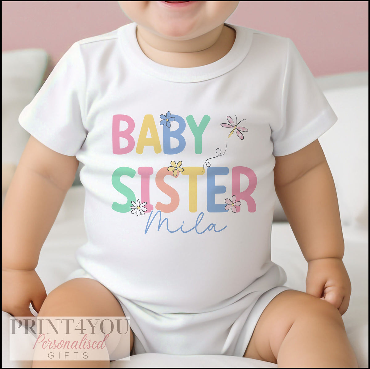 Personalised baby sister vest printed with a custom name.