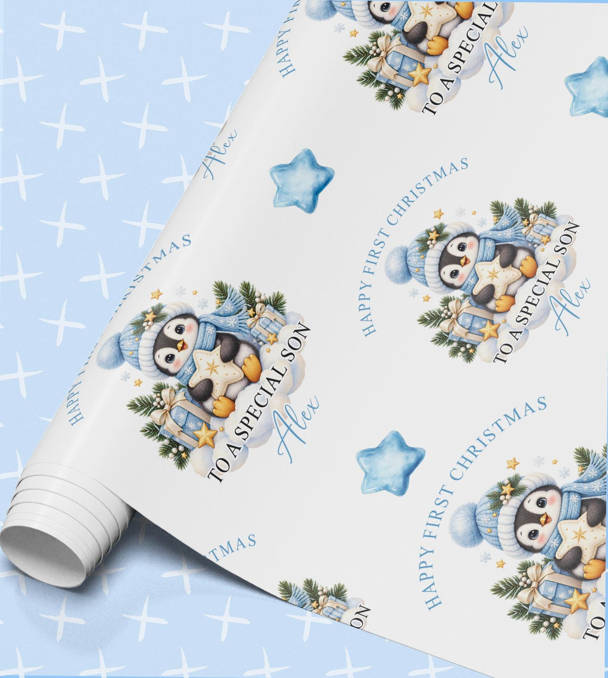 Rolled sheet of personalised baby first Christmas wrapping paper with penguins, blue stars and a name