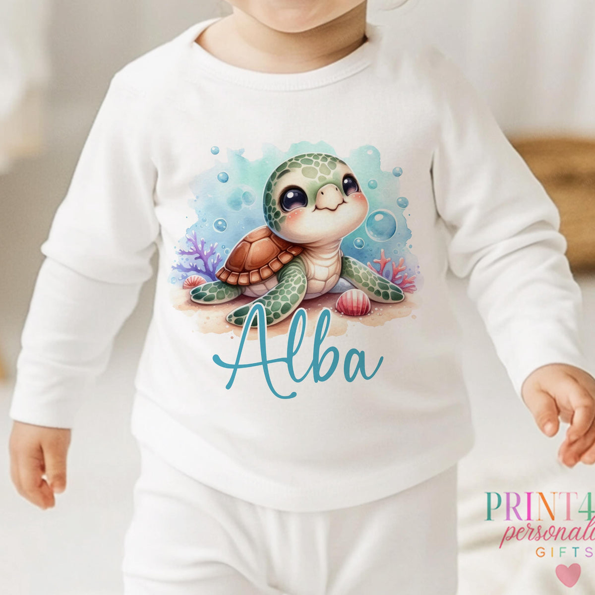 Personalised Sea Turtle sleepsuit for newborns, printed with baby's name below the design.