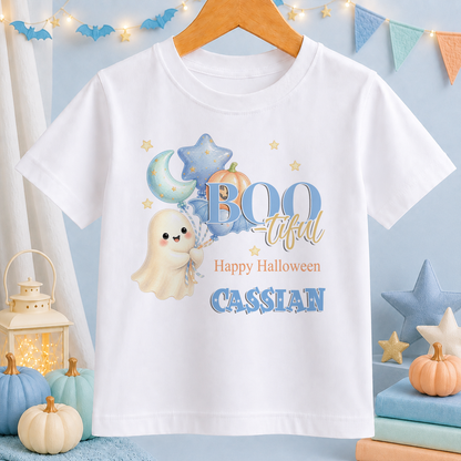 A white t-shirt with a Halloween-themed design, including a ghost, pumpkins, and stars, along with the text "BOO tacular Happy Halloween CASSIAN".