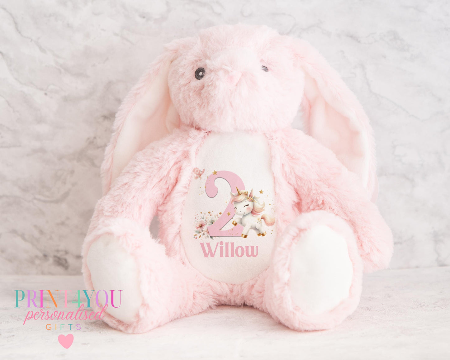 White personalised first birthday bunny soft toy with unicorn design printed on tummy