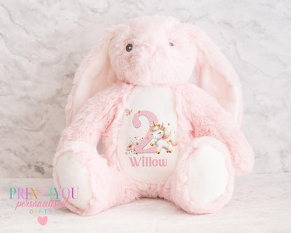 White personalised first birthday bunny soft toy with unicorn design printed on tummy