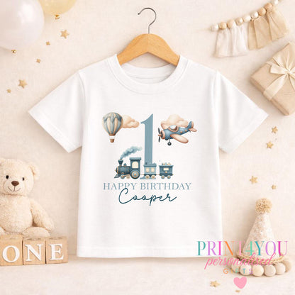 Personalised vintage transport first birthday T-shirt with a custom name printed under the balloon and train design.