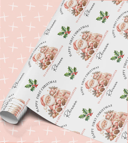Personalised baby first Christmas wrapping paper in pink with a sleeping baby Santa, holly and Happy First Christmas with relation and name