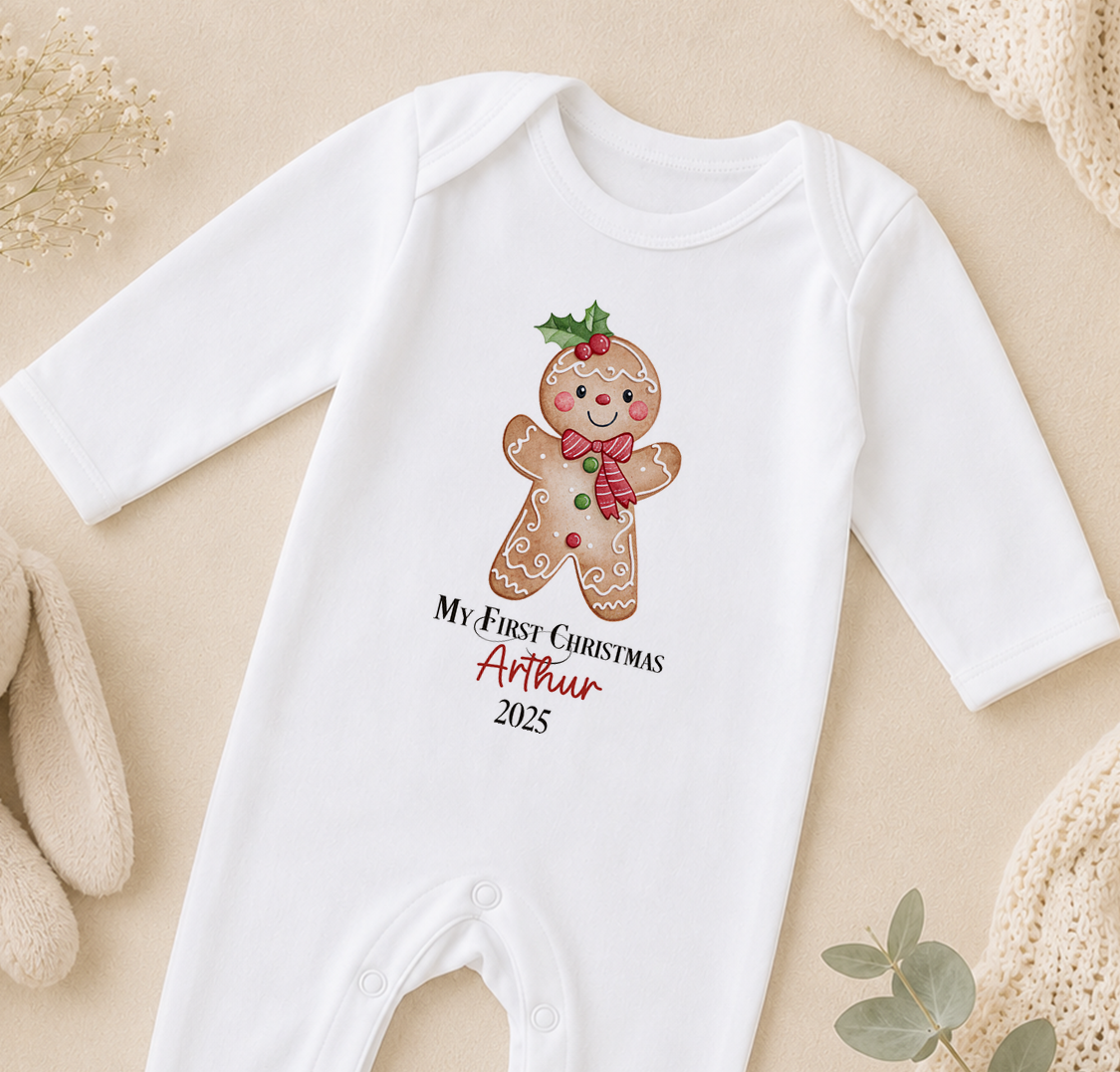 A white onesie with a gingerbread man design and text that says "My first Christmas Arthur 2020" printed on it.
