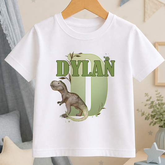 A white t-shirt with a dinosaur graphic and the name "Dylan" printed on it.