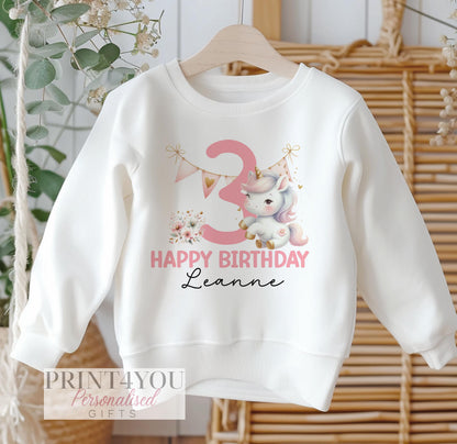 Personalised white cotton sweatshirt for children with pink party unicorn design, customised with name and birthday age