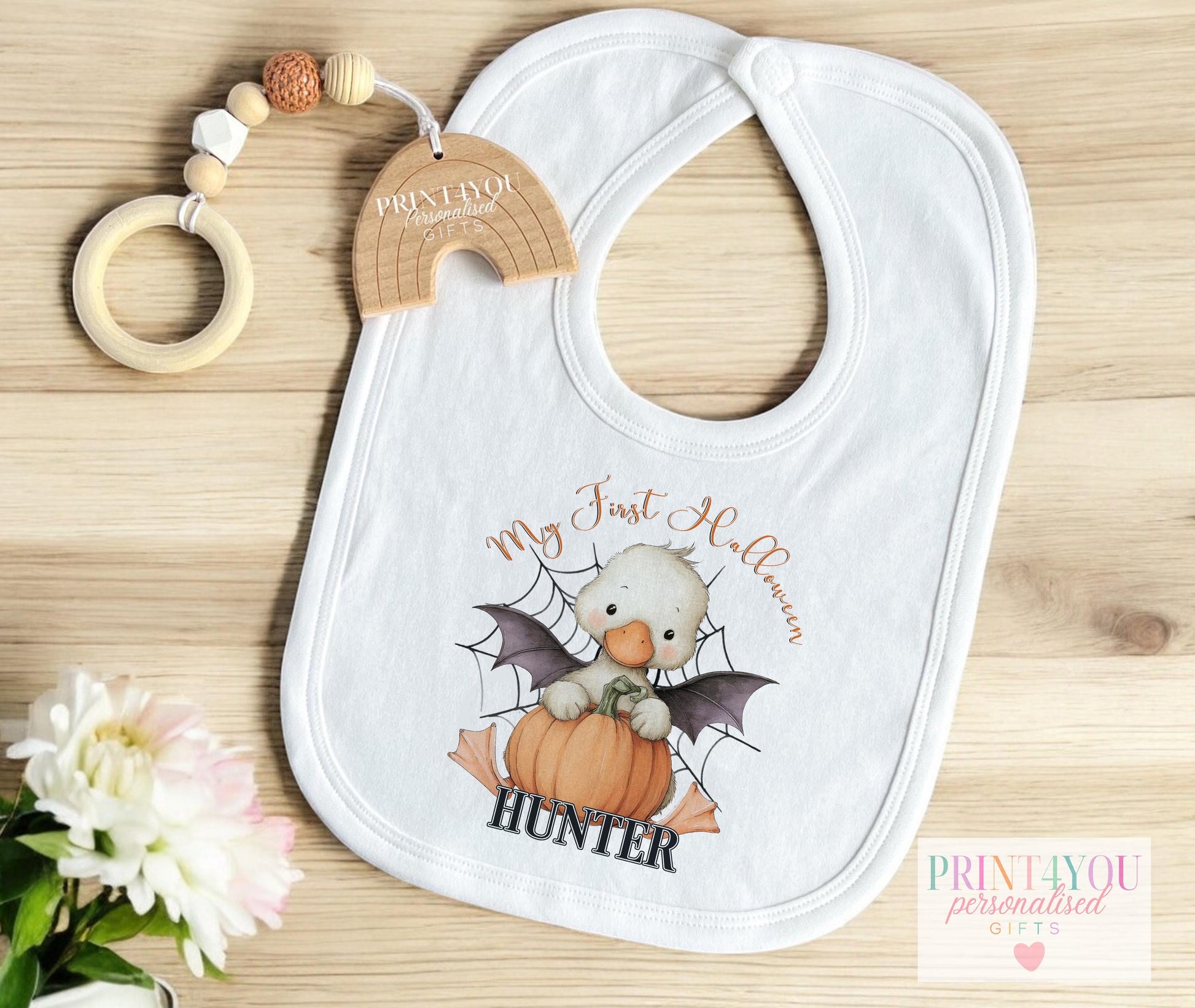 Personalised Halloween baby bib with the duck-in-pumpkin design and hook-and-loop fastening