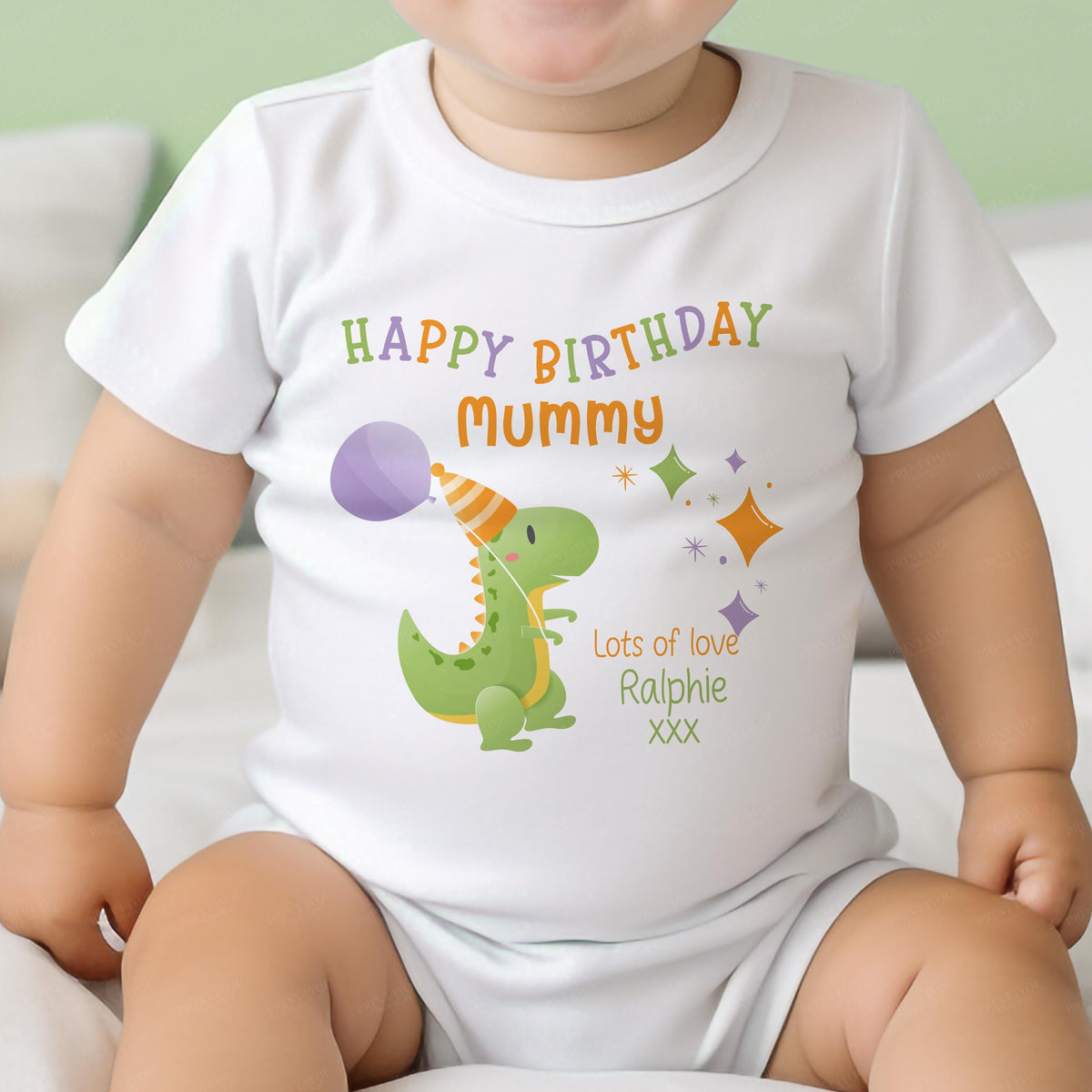 Close-up of the party dinosaur design with 'Happy Birthday' message and custom baby name
