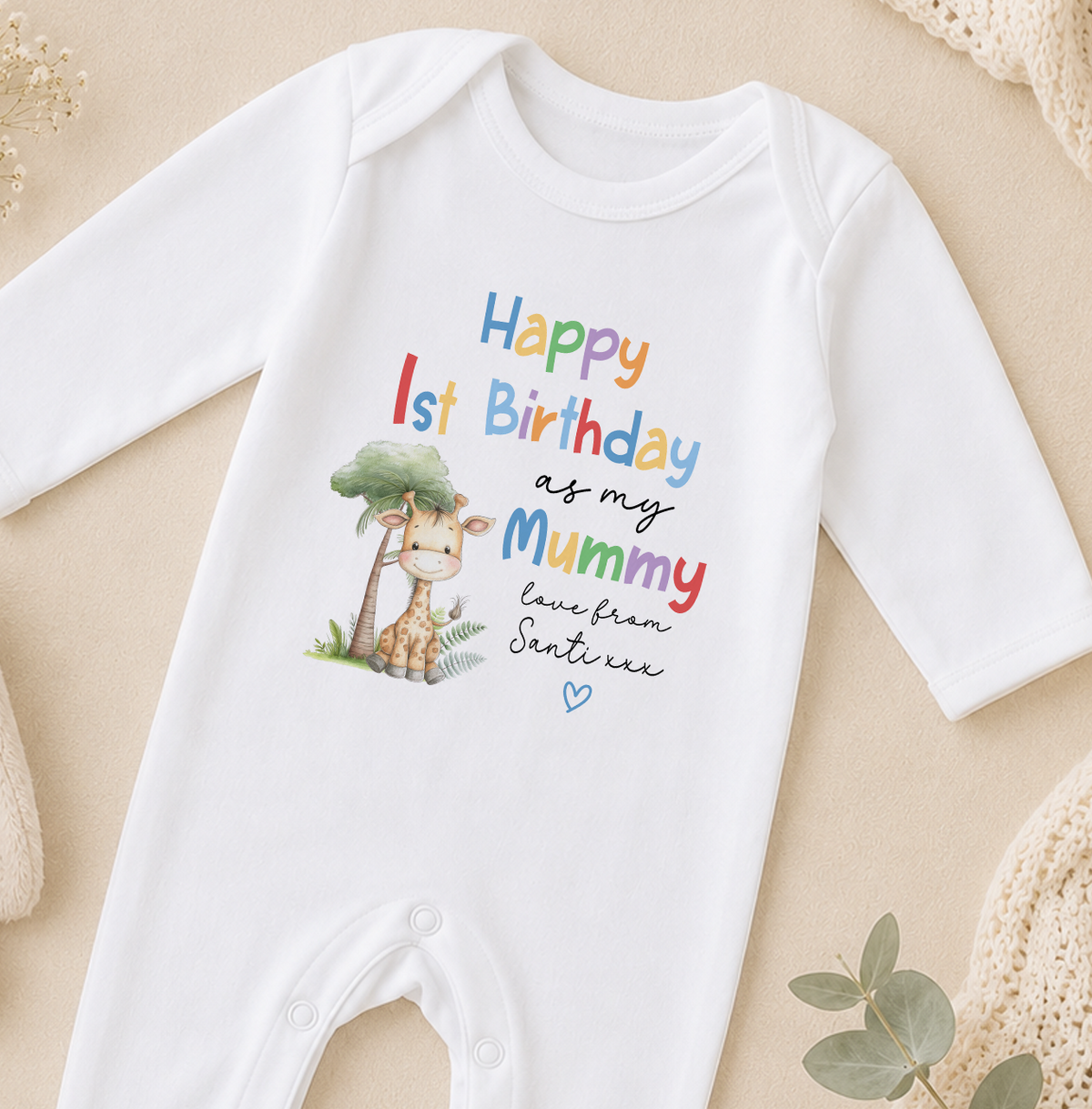 A white onesie with a giraffe and text that reads "Happy 1st Birthday as my Mummy love from Santi".