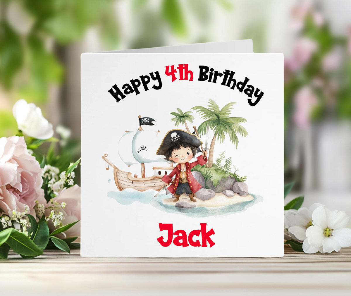 Personalised pirate birthday card with a colourful pirate ship and island scene, and the child's custom name printed in red on the front