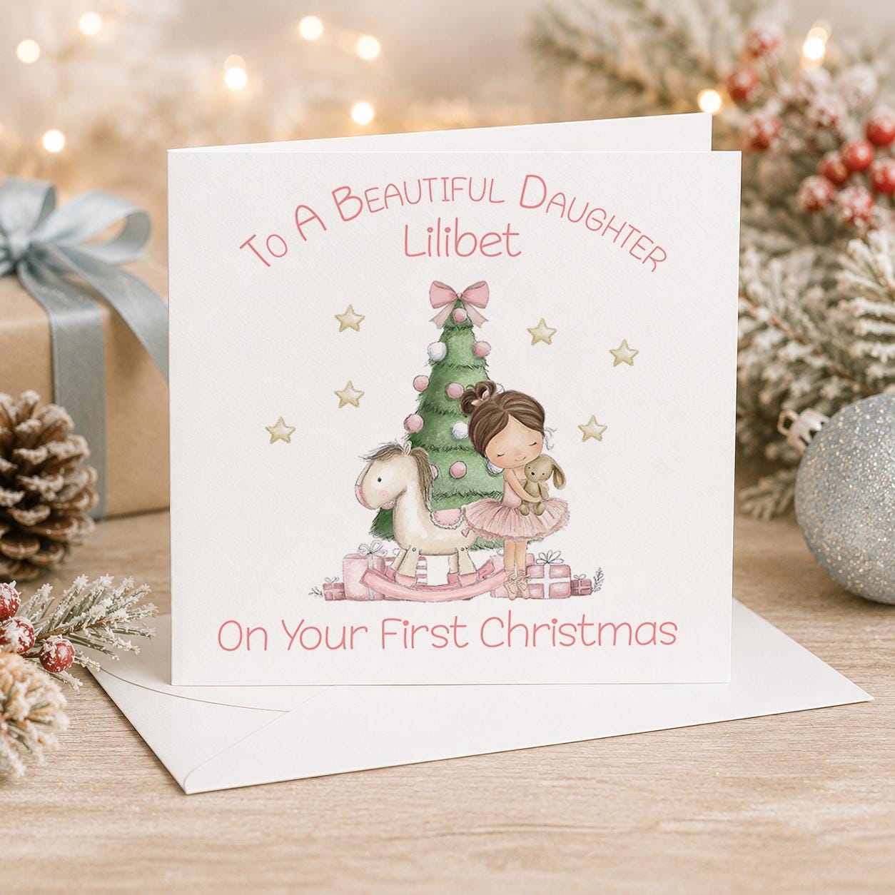 Personalised first Christmas card, white 6x6 inch square card printed with a little girl beside a Christmas tree and On Your First Christmas with a name