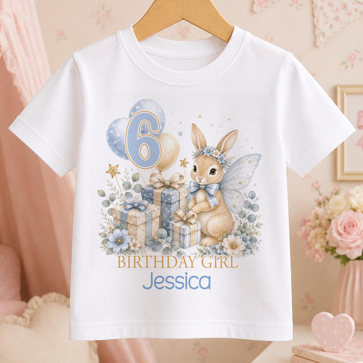 Personalised white t-shirt with a watercolour fairy bunny, blue balloons and presents, an age number and Birthday Girl above a name