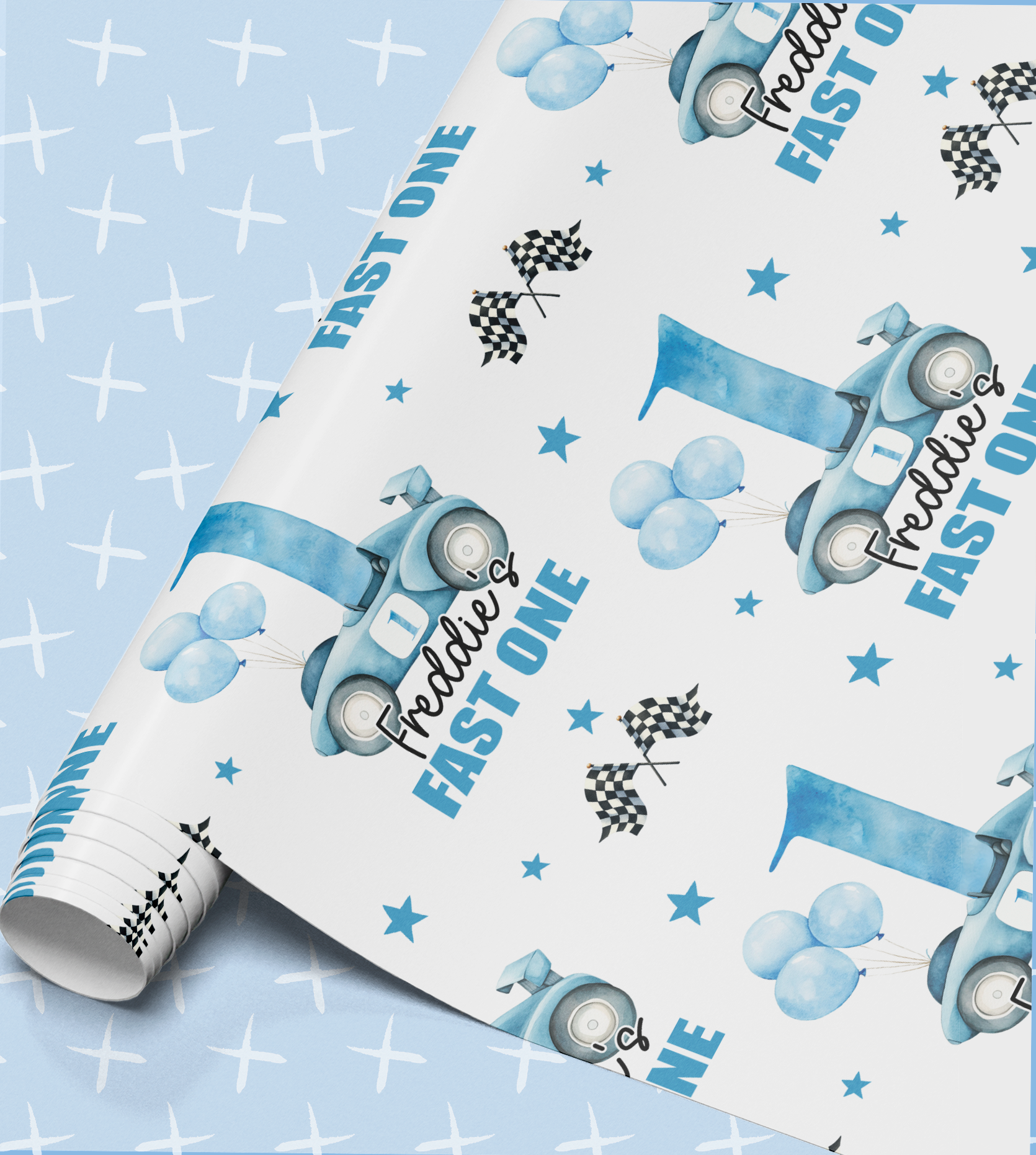 a roll of wrapping paper with a blue and white design, including a car, balloons, and stars. The text "FAST ONE" is visible, suggesting the paper is intended for a birthday celebration.