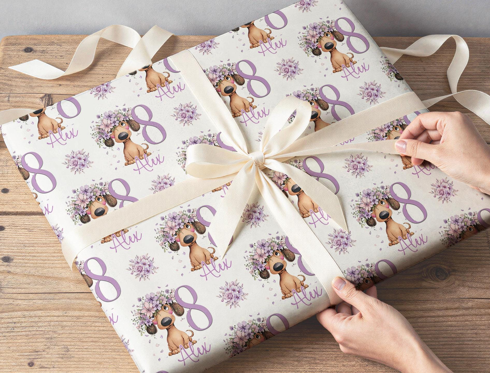 Wrapped gift finished in the personalised lilac floral dachshund birthday wrapping paper with a ribbon bow.