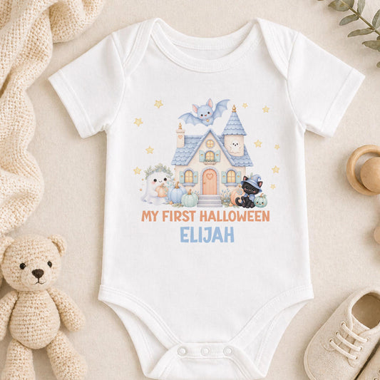Personalised baby’s first Halloween vest with a blue haunted house, friendly ghost, black kitten, bat, pumpkins and baby’s name.