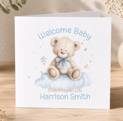 Square new baby boy card featuring a teddy bear on a blue cloud, personalised with 'Welcome Baby' and the baby's name and date of birth.