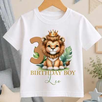A white t-shirt with a cartoon lion wearing a crown and the number 3, along with the text "BIRTHDAY BOY Leo".