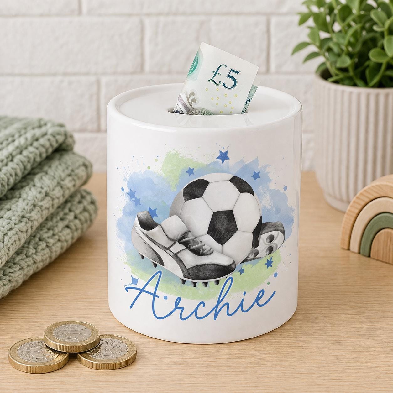 Ceramic money box printed with a personalised football boot design