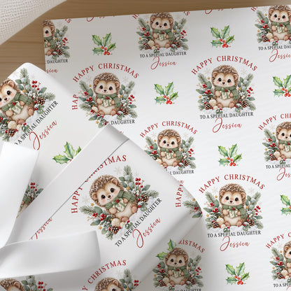 Sheets of the personalised hedgehog Christmas wrapping paper