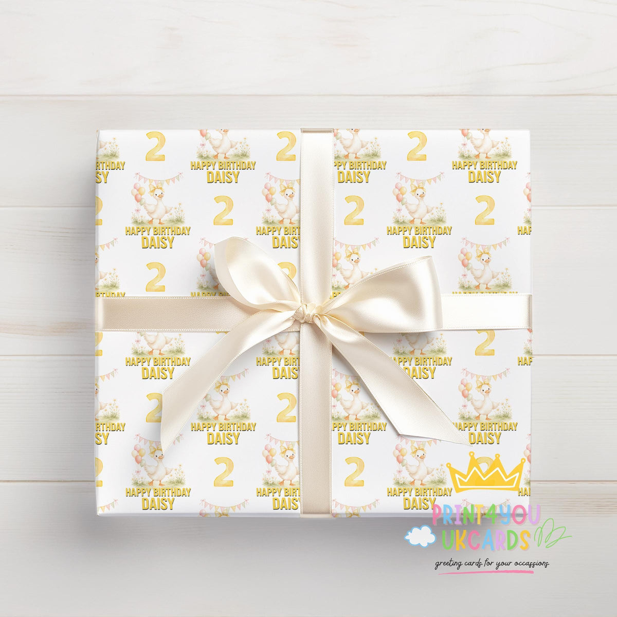 Personalised yellow duck balloon birthday wrapping paper wrapped around a gift box, tied and ready to give.