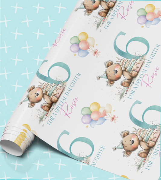a roll of wrapping paper with a repeating pattern of a teddy bear wearing a party hat and balloons, along with the text "For a special daughter Rose".