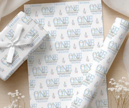 Close-up of the pastel blue duck wrapping paper pattern with the personalised name printed throughout.