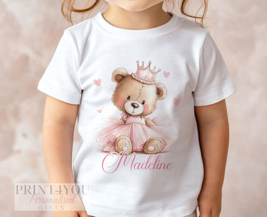 White children's t-shirt printed with an illustrated teddy bear wearing a pink tutu and jewelled crown, surrounded by pink hearts