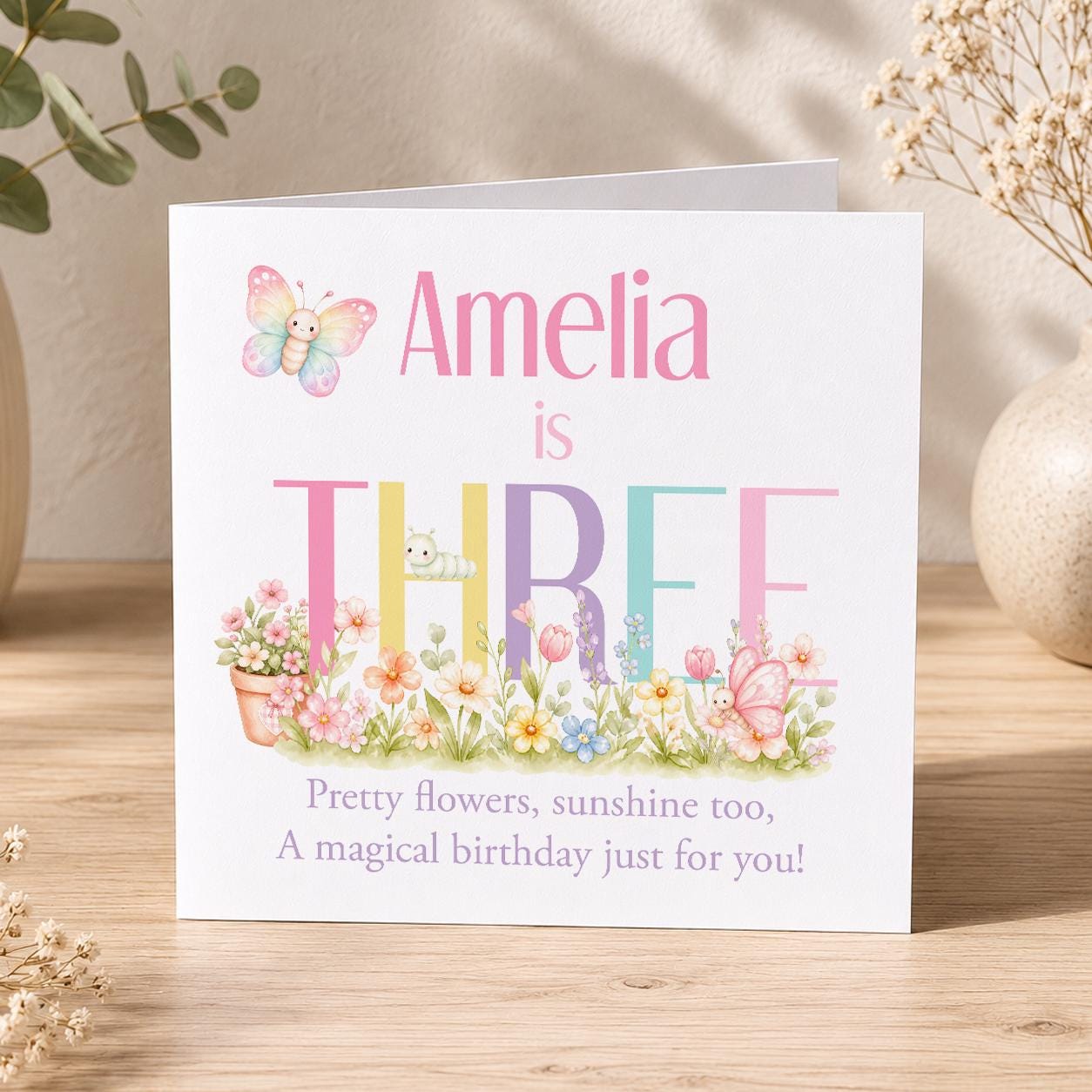 Square girls' birthday card with a butterfly and pastel floral design, personalised with a name, age and relation.