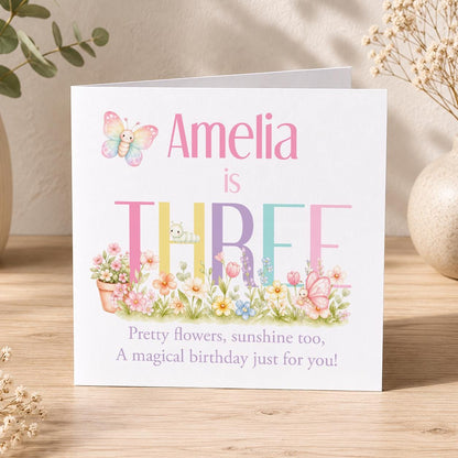 Square girls' birthday card with a butterfly and pastel floral design, personalised with a name, age and relation.