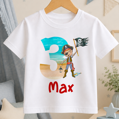 A white t-shirt with a pirate-themed design, including a pirate flag and a cartoon character, along with the text "Max" printed on it.