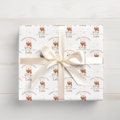 Roll of personalised polar bear Christmas wrapping paper packaged in a postal tube ready for delivery.