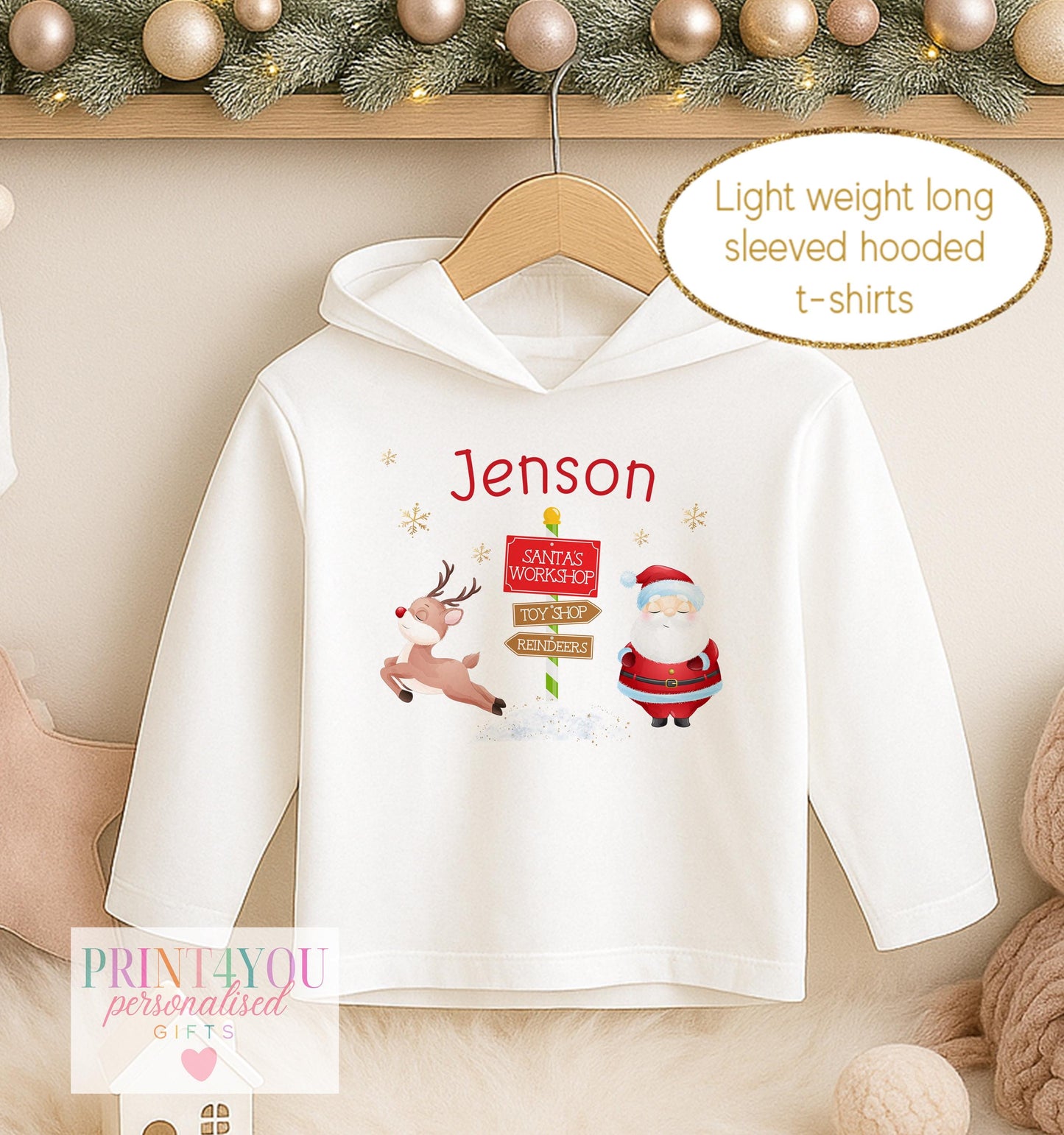 Personalised Christmas hooded t-shirt for kids, white lightweight long sleeved hoodie printed with Santa beside a North Pole signpost and a name
