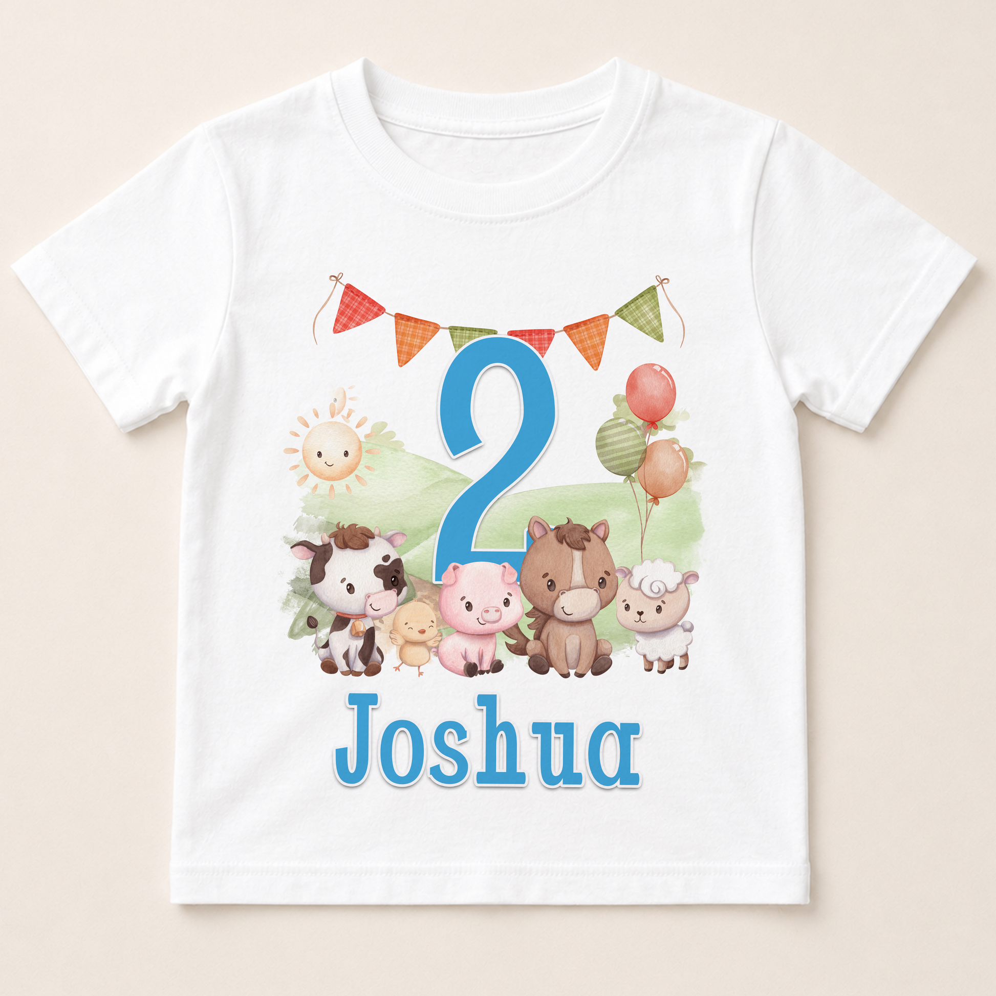 A white t-shirt with a cartoon image of various animals, including a horse, cow, pig, sheep, and a sun, along with a number 2 and the name " Joshua" printed on it.