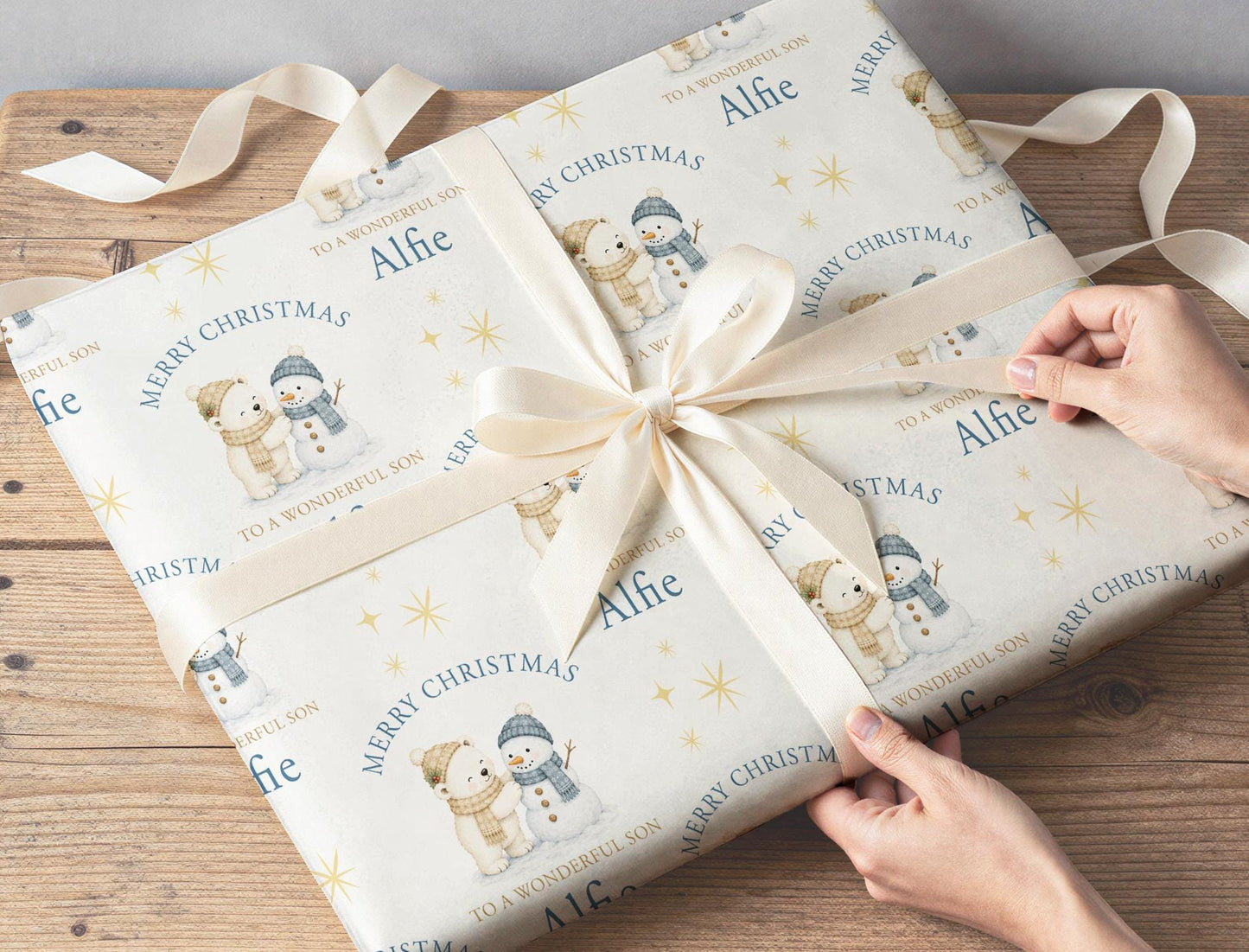 Personalised polar bear and snowman wrapping paper roll shown with custom name example