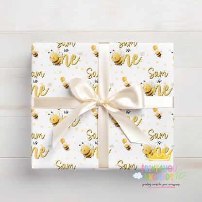 Personalised bee birthday wrapping paper sheet laid flat showing the full pattern