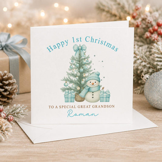 Personalised first Christmas card, white 6x6 inch square card printed with a snowman, a blue Christmas tree and Happy 1st Christmas with a name