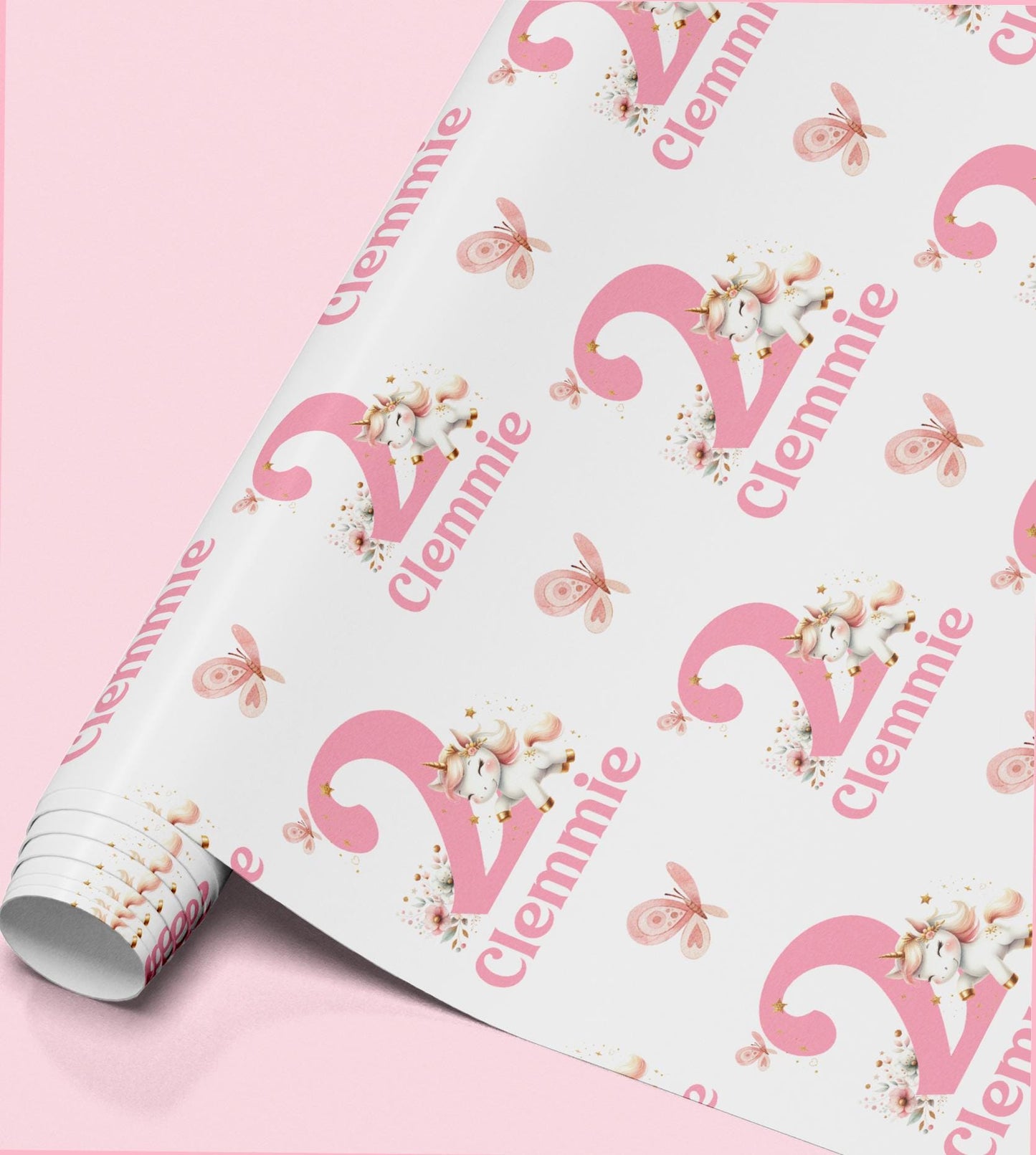 Pink and white unicorn wrapping paper personalised with the name 'Clennie', repeated across the pattern with butterflies