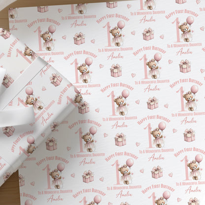Close-up of the personalised pink ballerina teddy bear first birthday wrapping paper, showing the balloon, gift box and custom name detail.