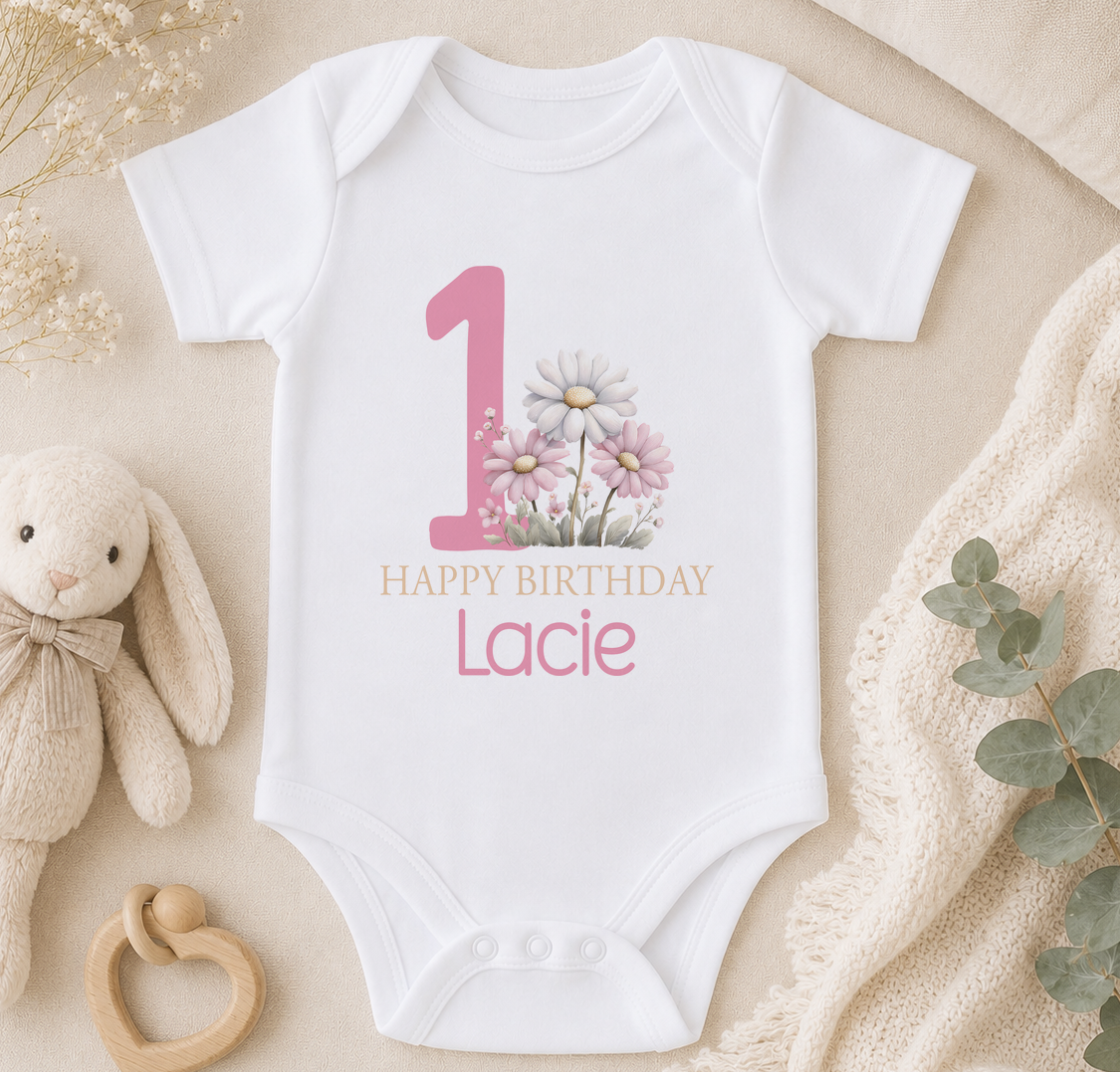 Personalised pink floral 1st birthday babygrow styled with a soft toy bunny