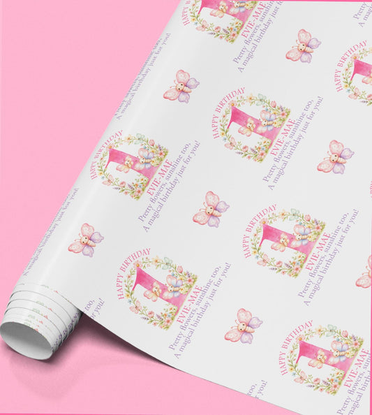 a roll of paper with a repeating pattern of butterflies and a pink number one on it.