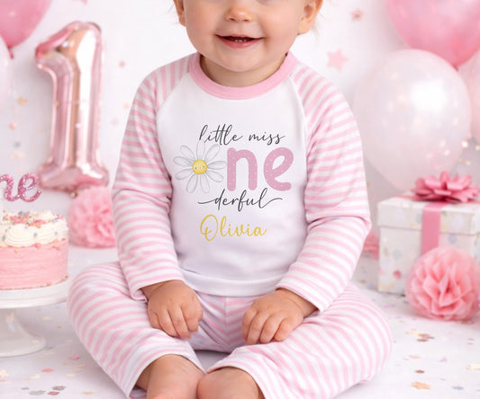 Personalised first birthday pyjamas with daisy party design and custom name, soft cotton