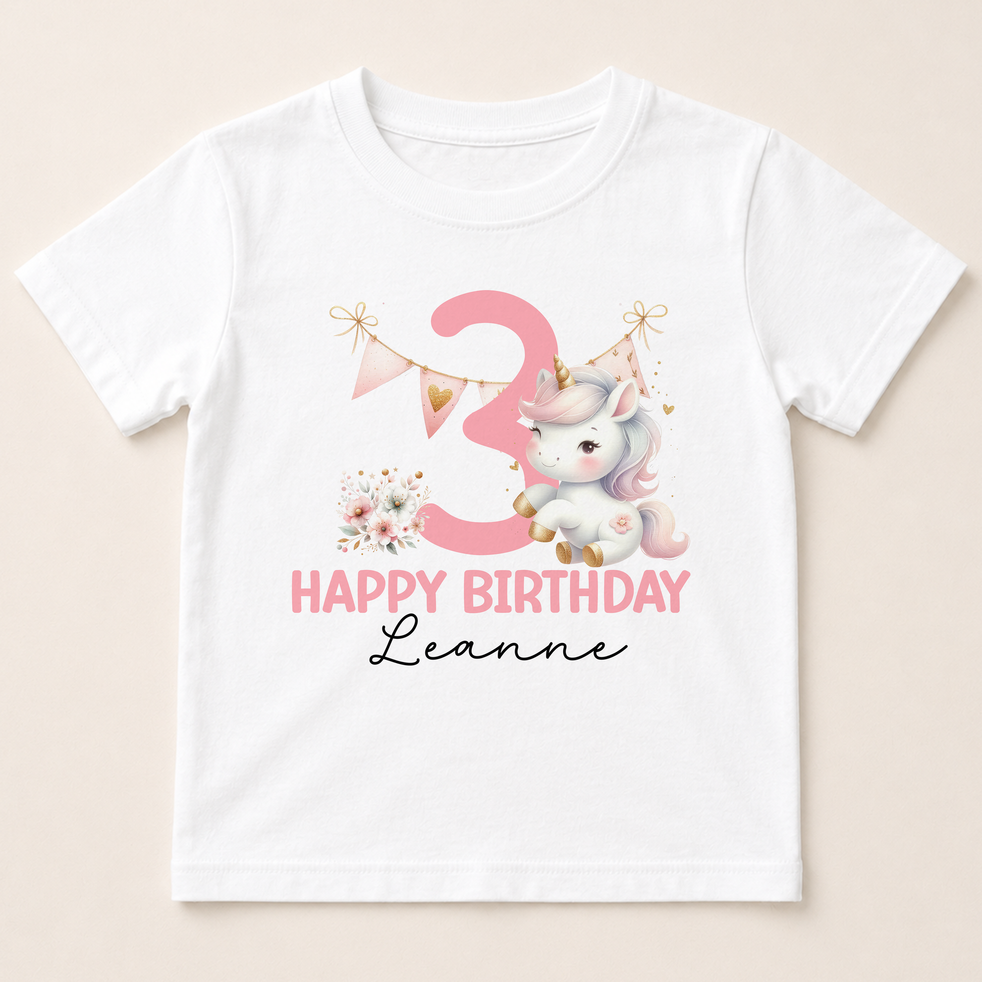 A white t-shirt with a pink unicorn and the number 3 printed on it, along with the text "Happy Birthday Leanne".