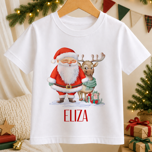 A white t-shirt with a Christmas-themed graphic design featuring Santa Claus and a reindeer, along with the name "ELIZA" printed below.