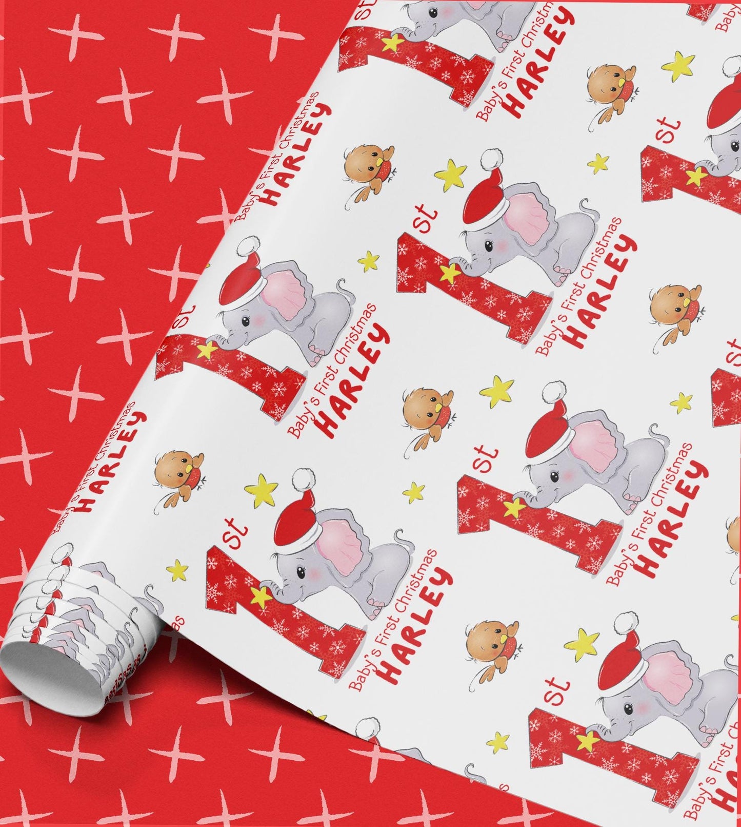 Roll of personalised Baby's First Christmas wrapping paper with an elephant in a Santa hat design and custom name printed throughout.